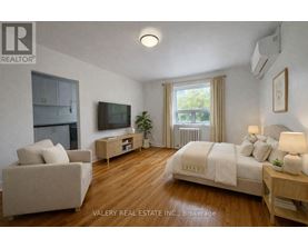 A bedroom with a bed, couch, and television.