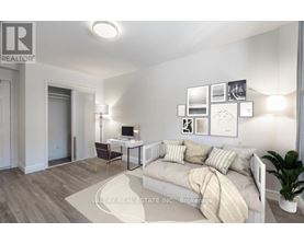 A bedroom with a bed, desk, and chair.