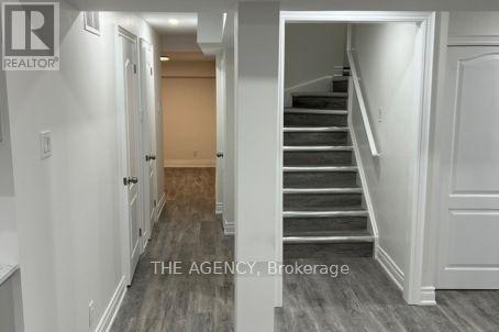 A hallway with a staircase leading to the second floor.