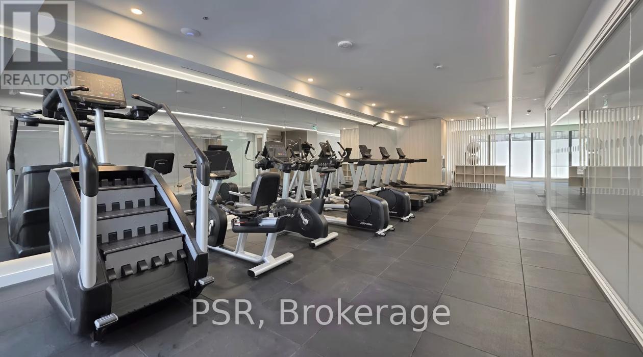 A gym with a variety of equipment including treadmills, weights, and exercise machines.
