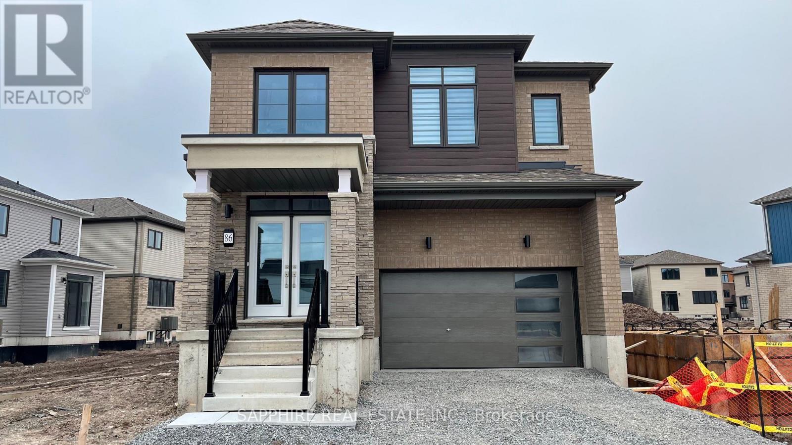 A modern two-story house with a garage is for sale.