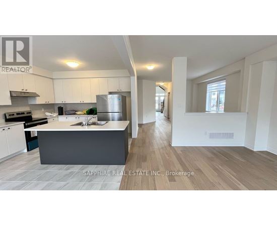 A modern kitchen with white cabinets and a central island.