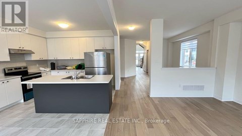 A modern kitchen with white cabinets and a central island.