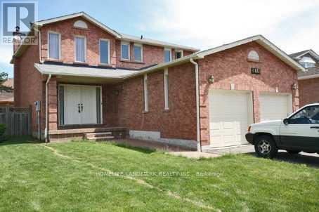 A red brick house with a white garage door and a car parked in front.