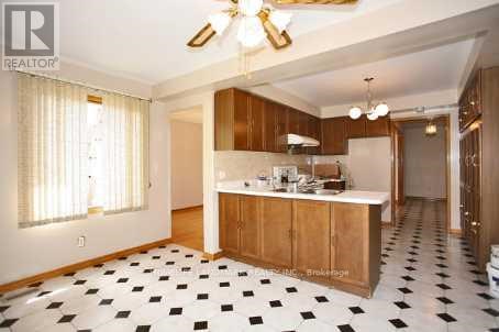 A kitchen with black and white tiles on the floor.
