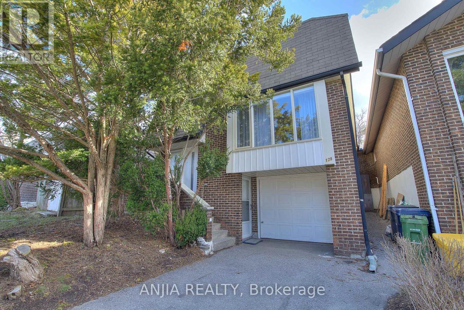 A house with a tree in front of it is for sale.