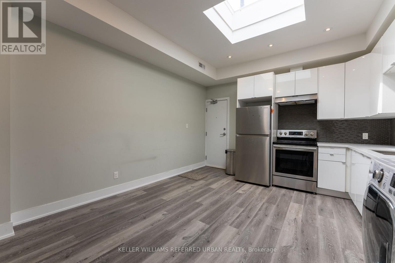 A spacious kitchen with a skylight above the counter.