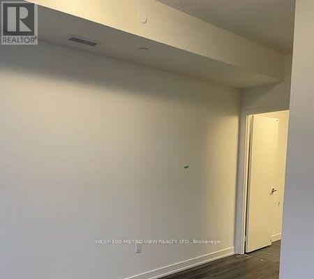A white interior room with a door on the right.