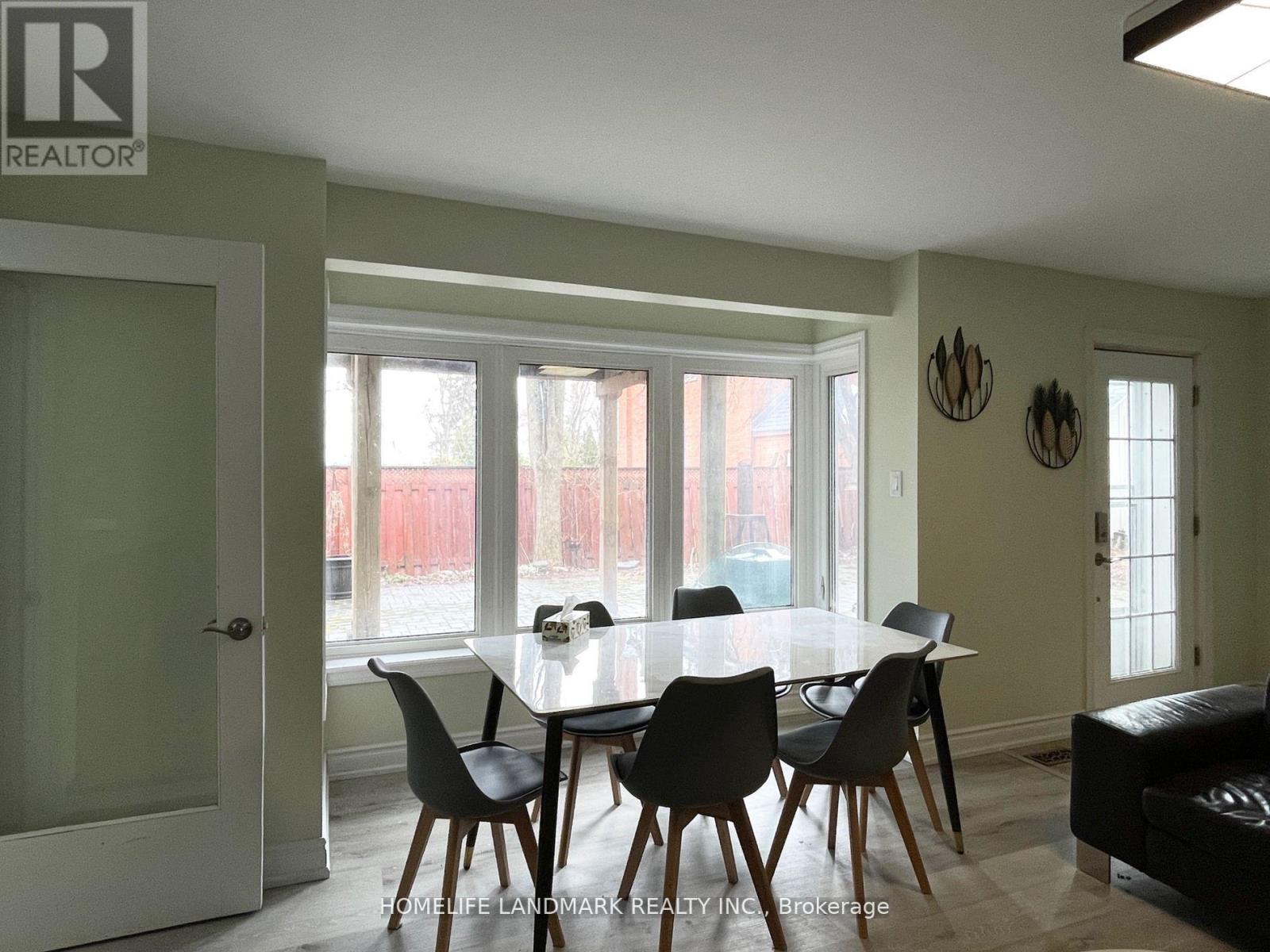 A dining room with a table set for four.
