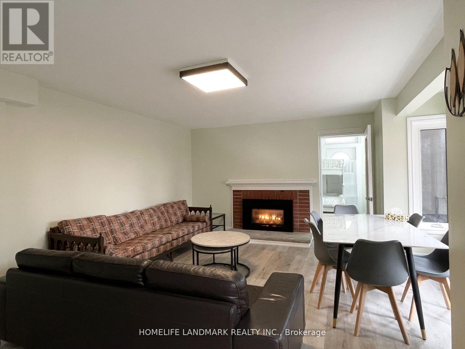A living room with a fireplace and a couch.