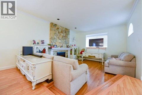 A living room with a white sofa and a white coffee table.