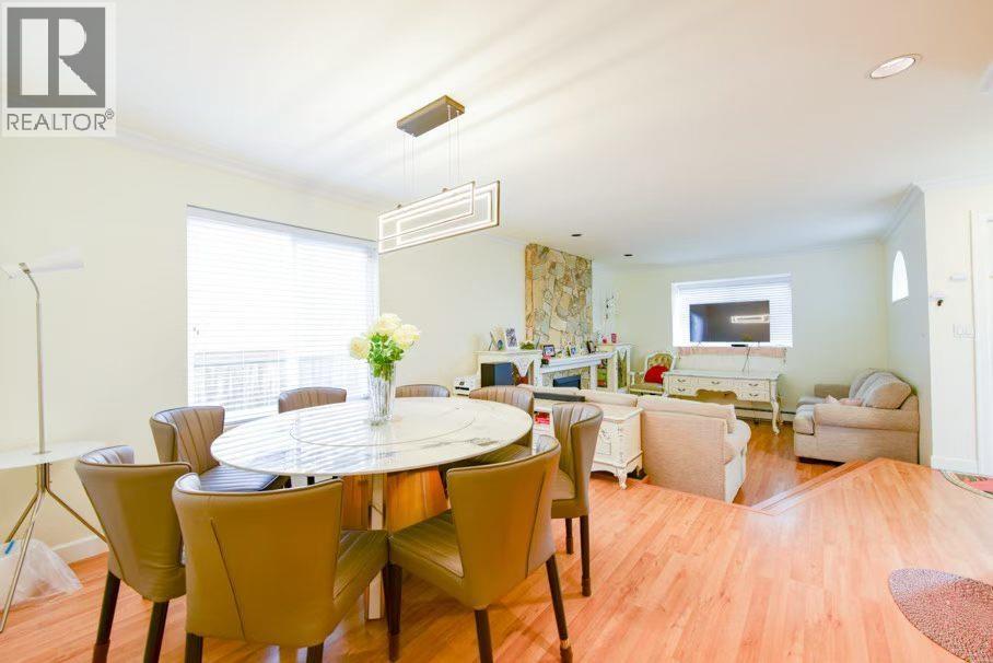 A well-lit dining room with a table set for six.