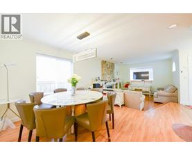 A well-lit dining room with a table set for six.