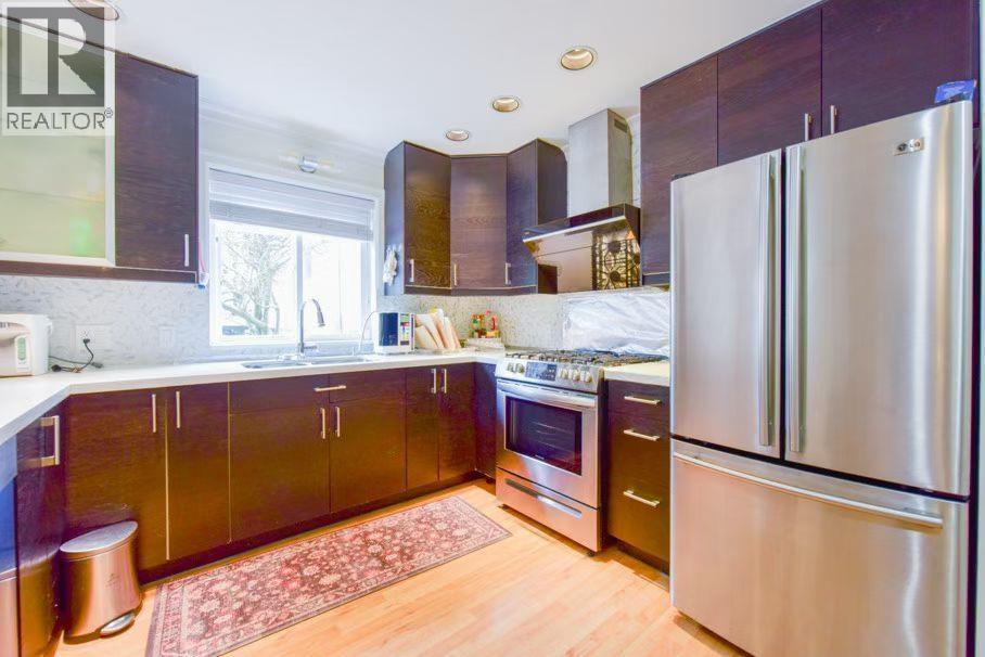 A kitchen with a refrigerator on the right side.