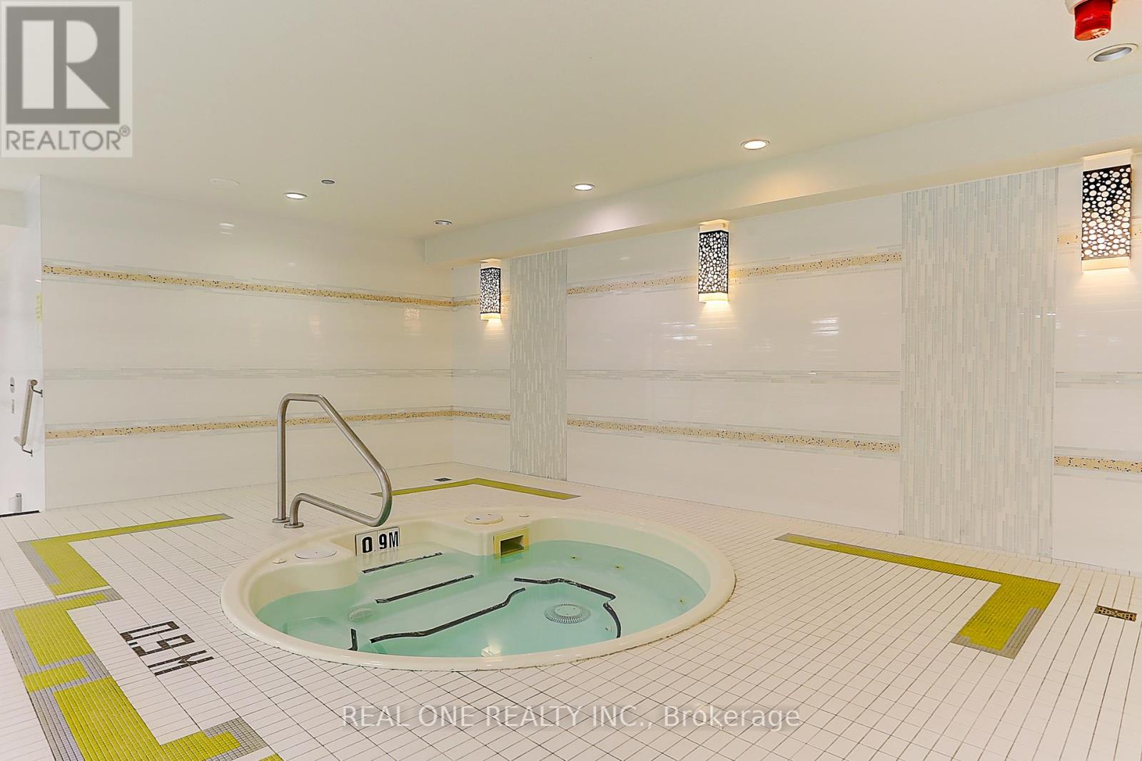A hot tub in a room with a white tile floor.