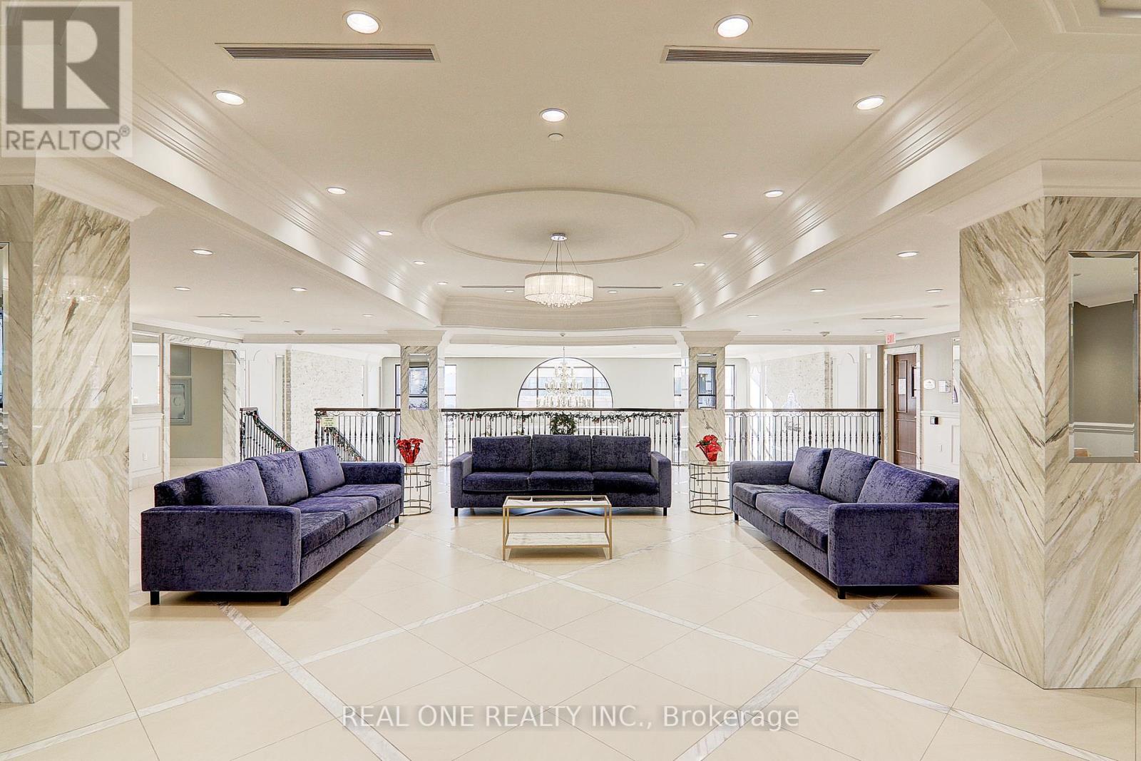 A spacious living room with a large sofa set and a coffee table.