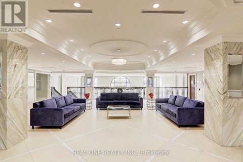 A spacious living room with a large sofa set and a coffee table.