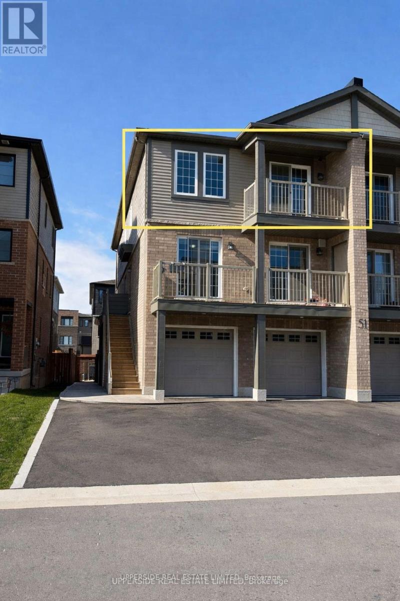 A two-story residential building with a garage is for sale.