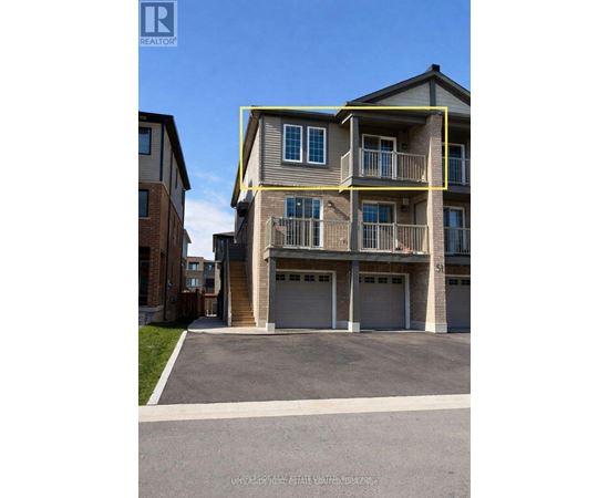A two-story residential building with a garage is for sale.