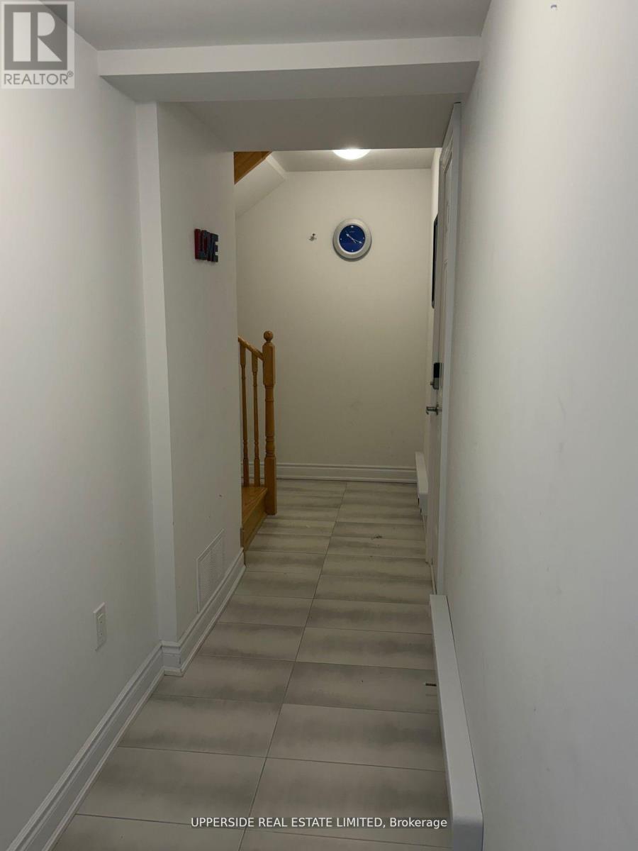 A hallway with a blue circular sign on the wall.