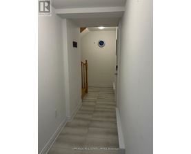 A hallway with a blue circular sign on the wall.