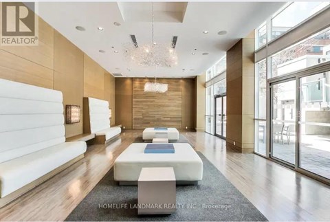 A spacious living room with a white sofa and a wooden floor.