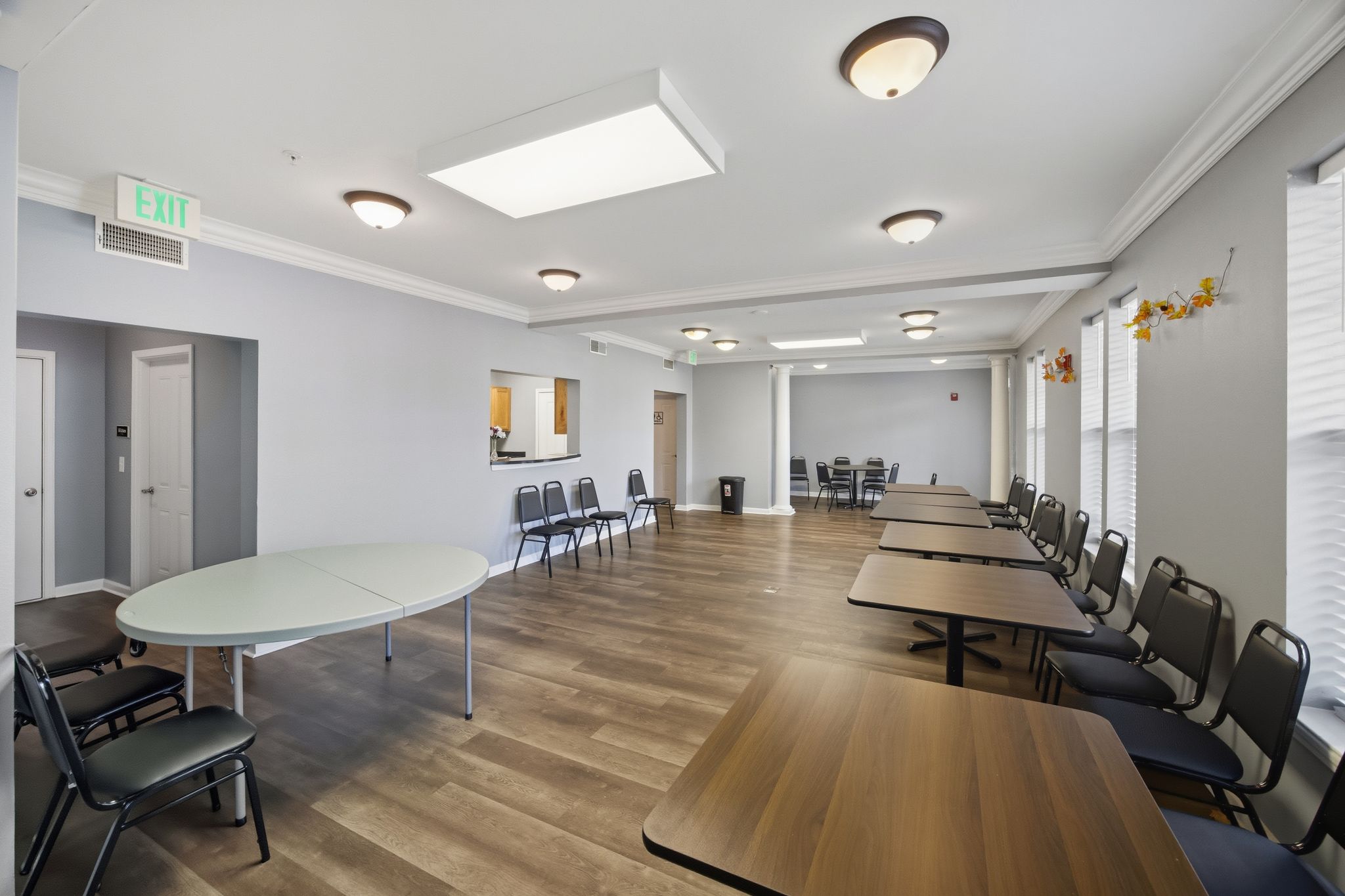 A conference room with a long table and chairs.