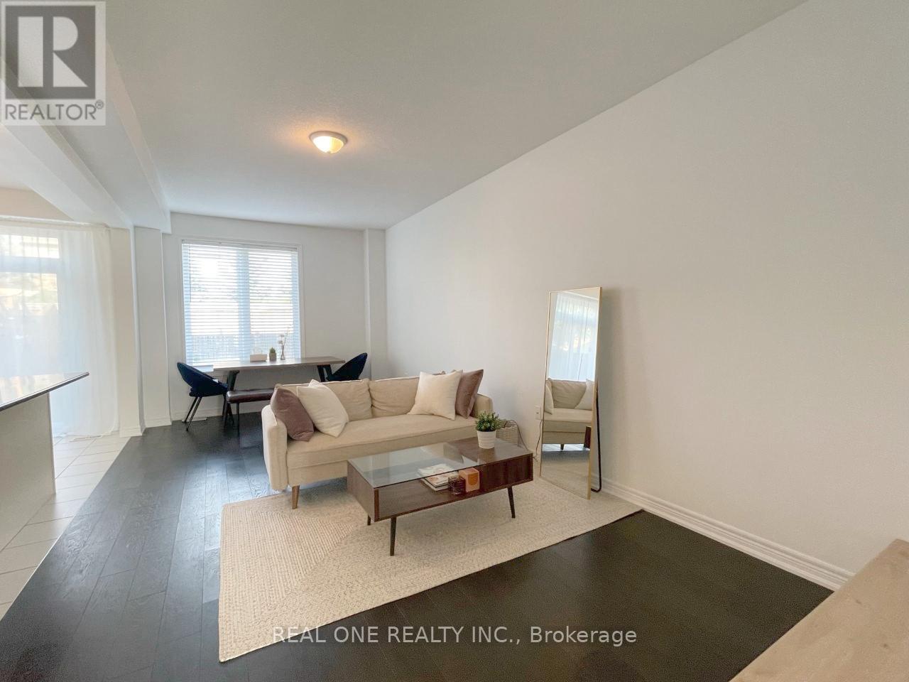A living room with a white couch and a coffee table.
