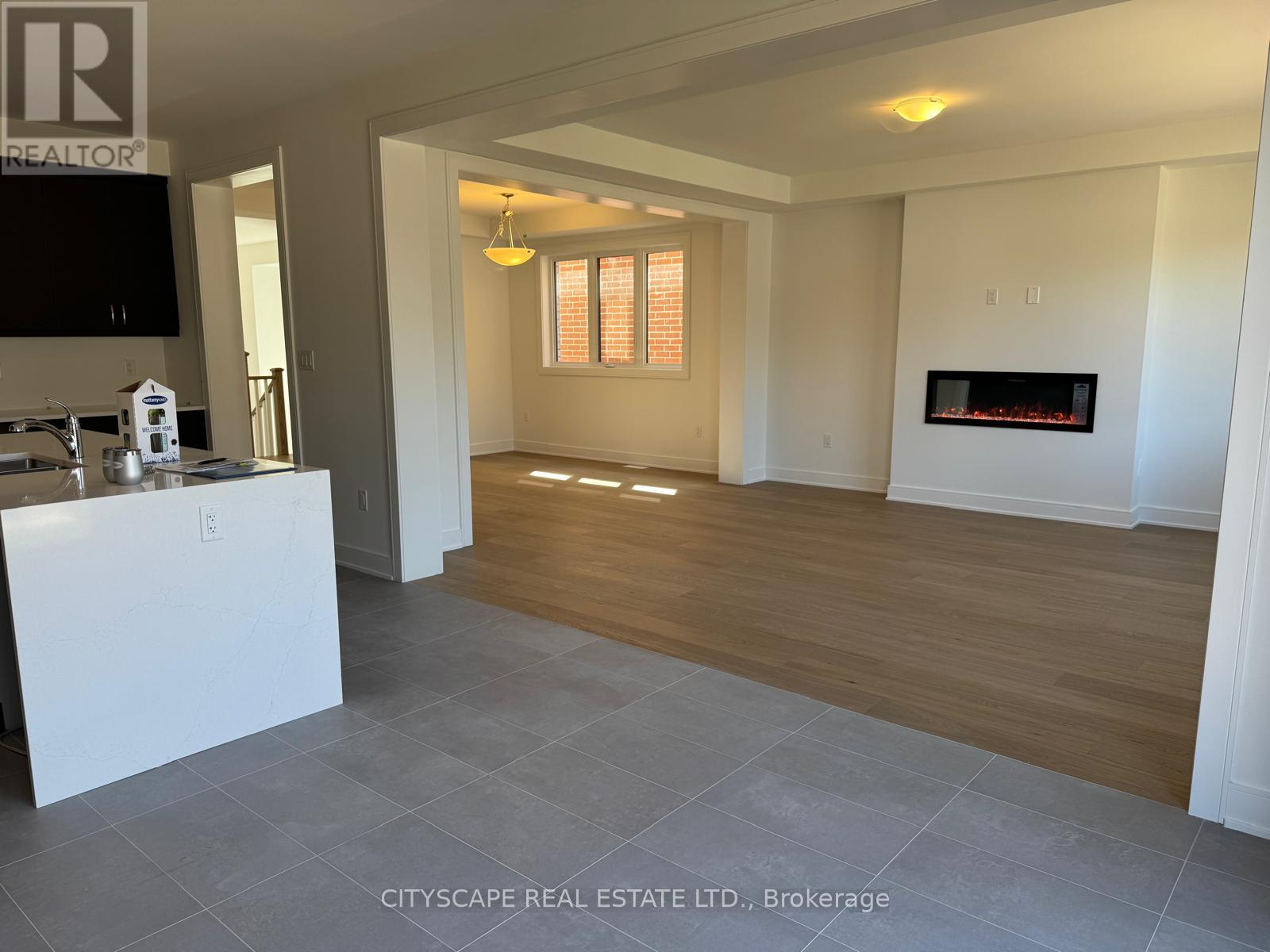 A living room with a fireplace and a television.