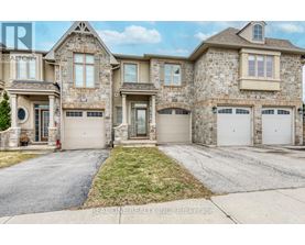 A large, two-story house with a stone facade and multiple garages.