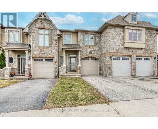 A large, two-story house with a stone facade and multiple garages.