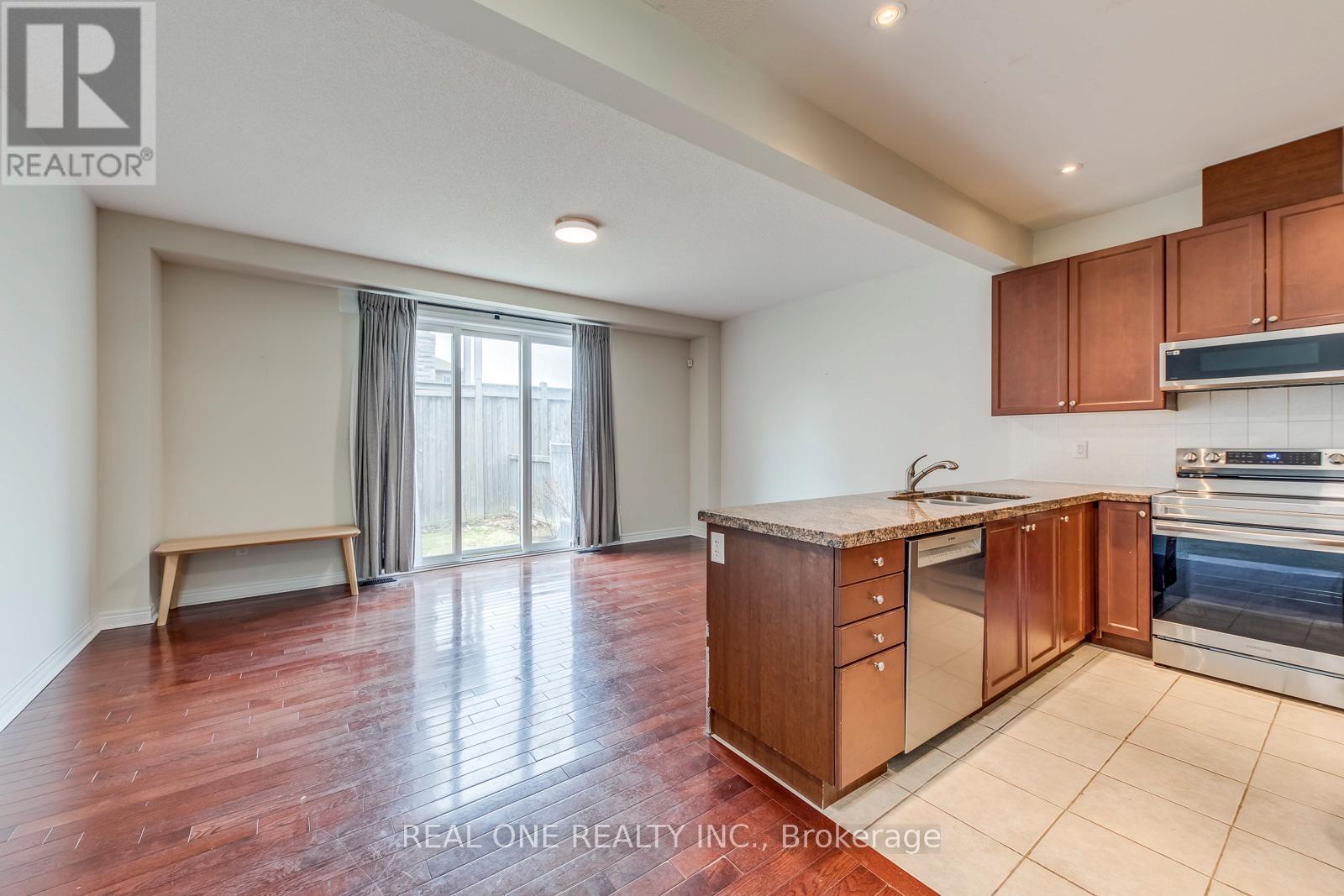 A kitchen with wooden cabinets and a stainless steel oven.
