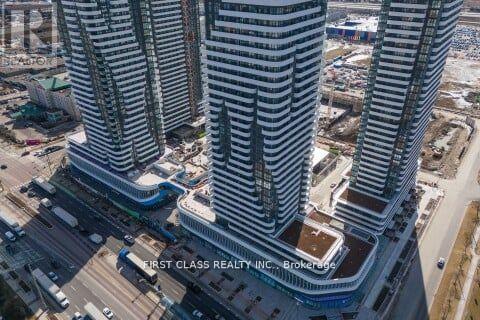 Two tall buildings with the text "First Class Realty Inc. Brokerage" on the side.