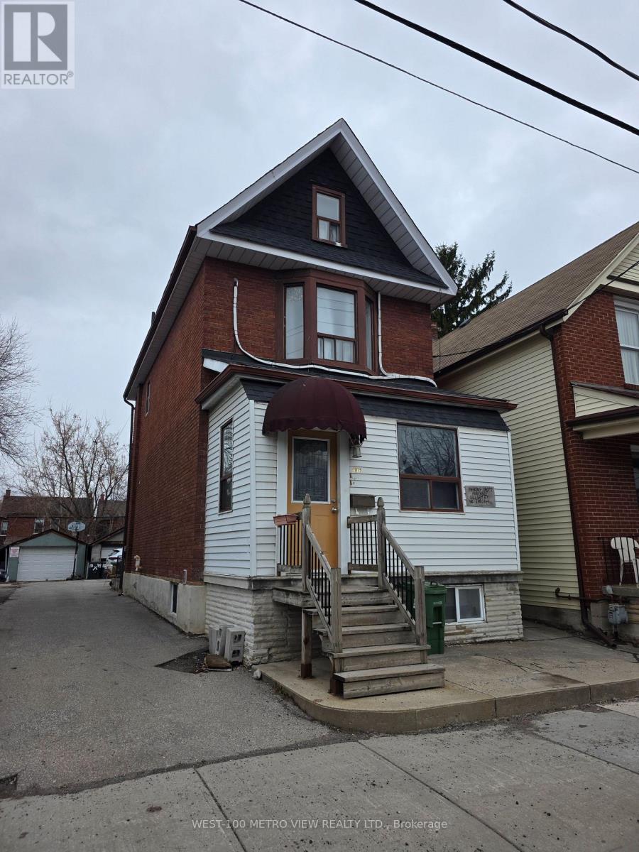 A house with a brown door and a brown roof.