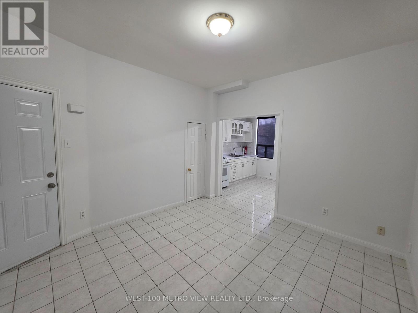 A white room with a door and a window.