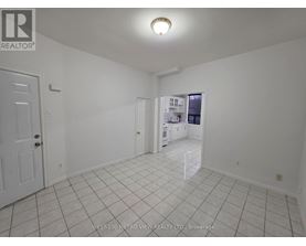 A white room with a door and a window.