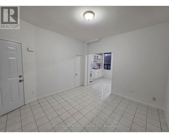 A white room with a door and a window.