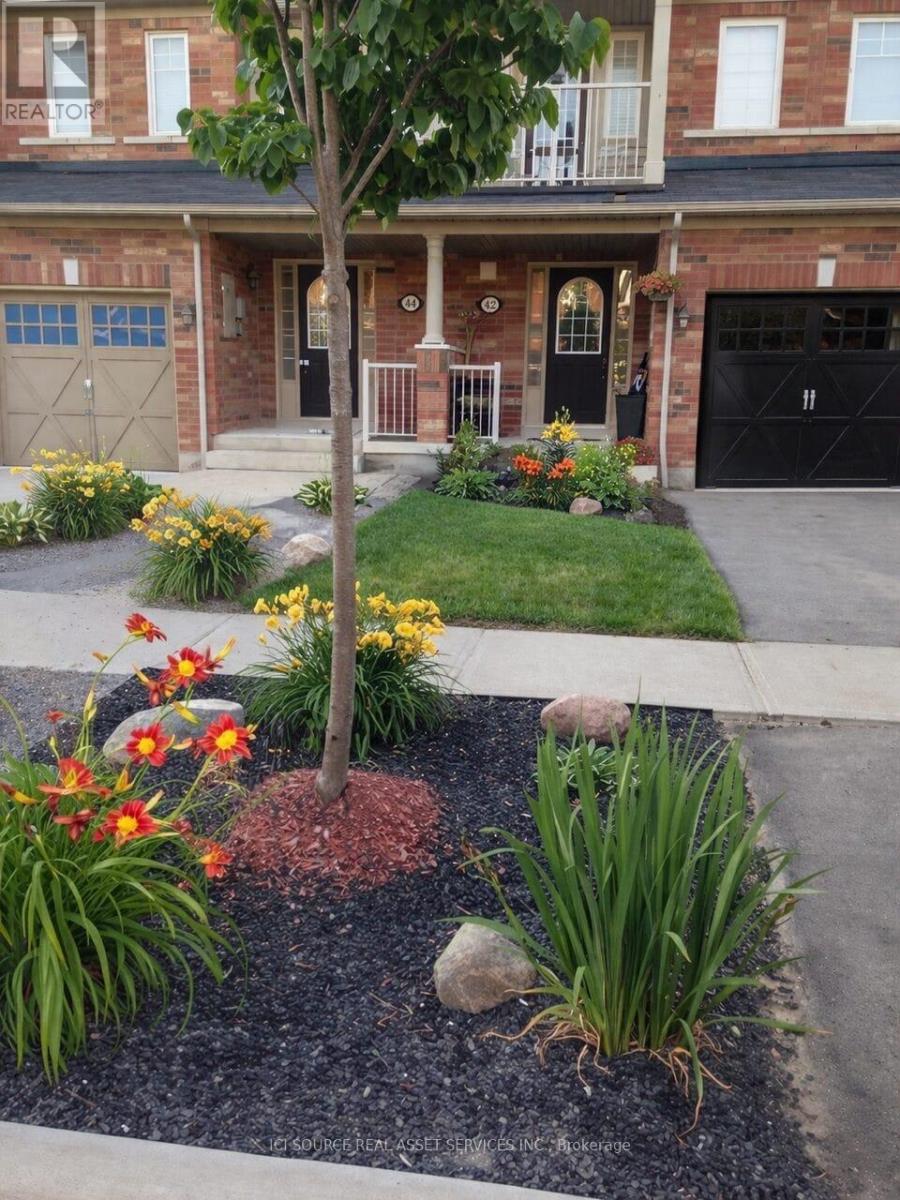 A house with a front yard and a tree.