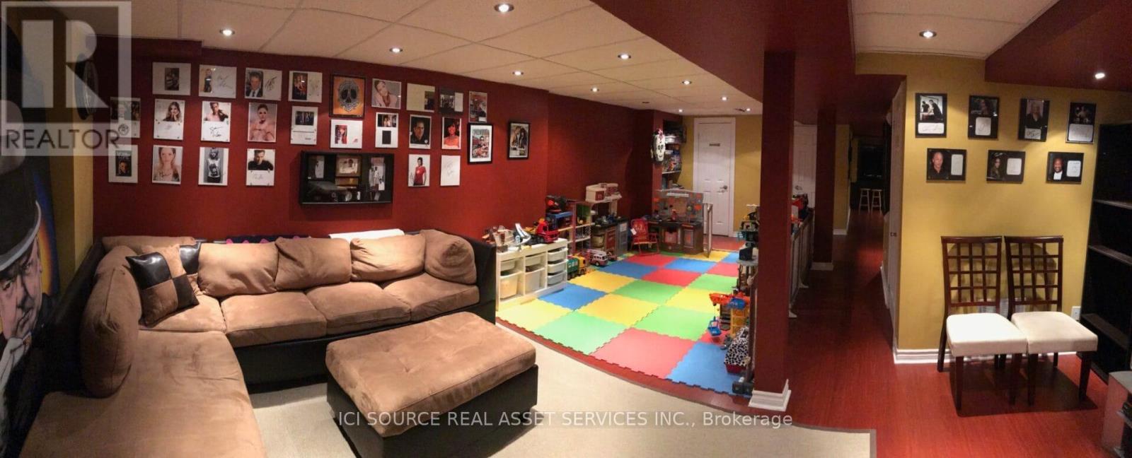 A living room with a couch and a colorful rug.