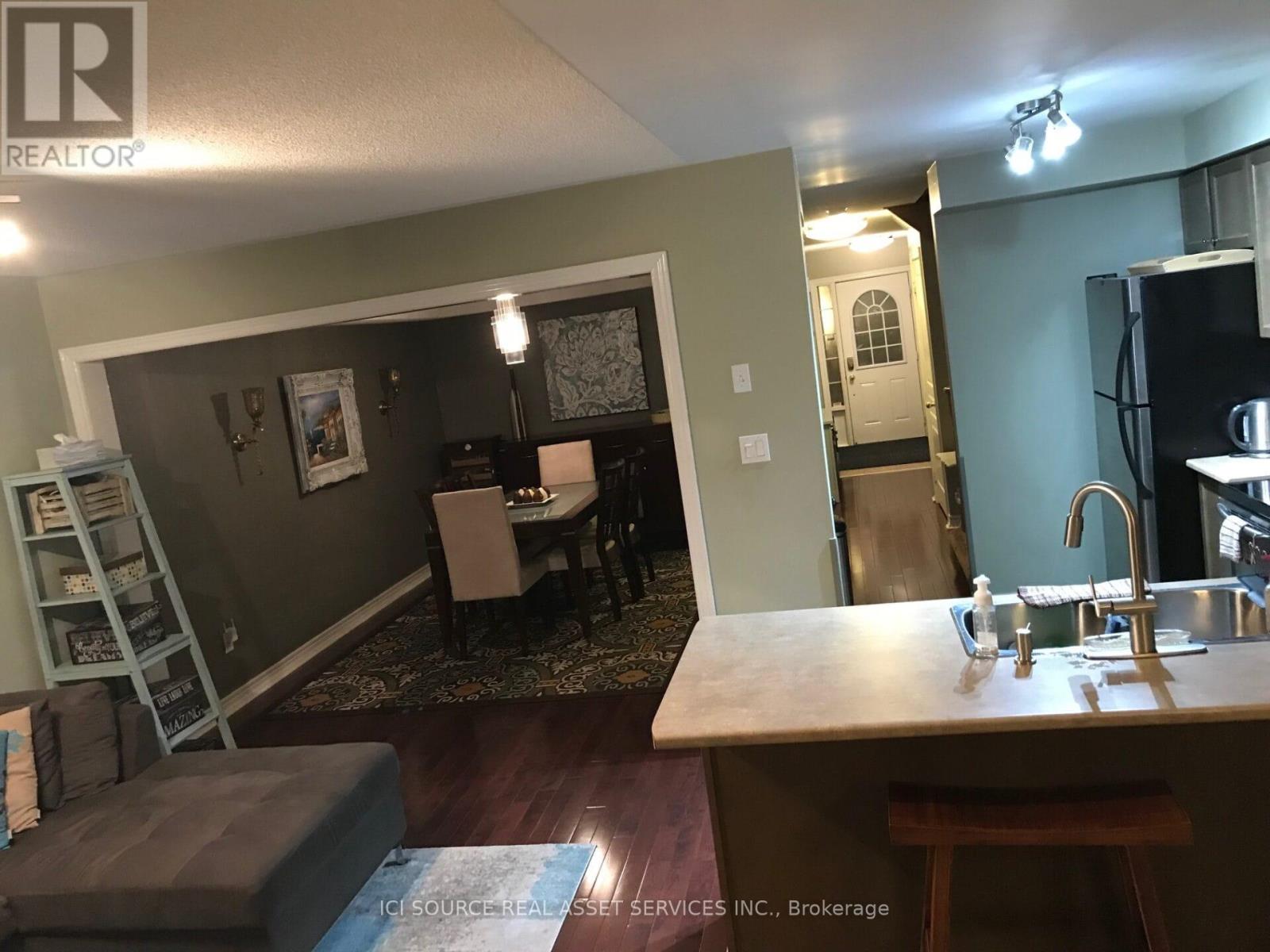 A kitchen with a sink and a dining table.