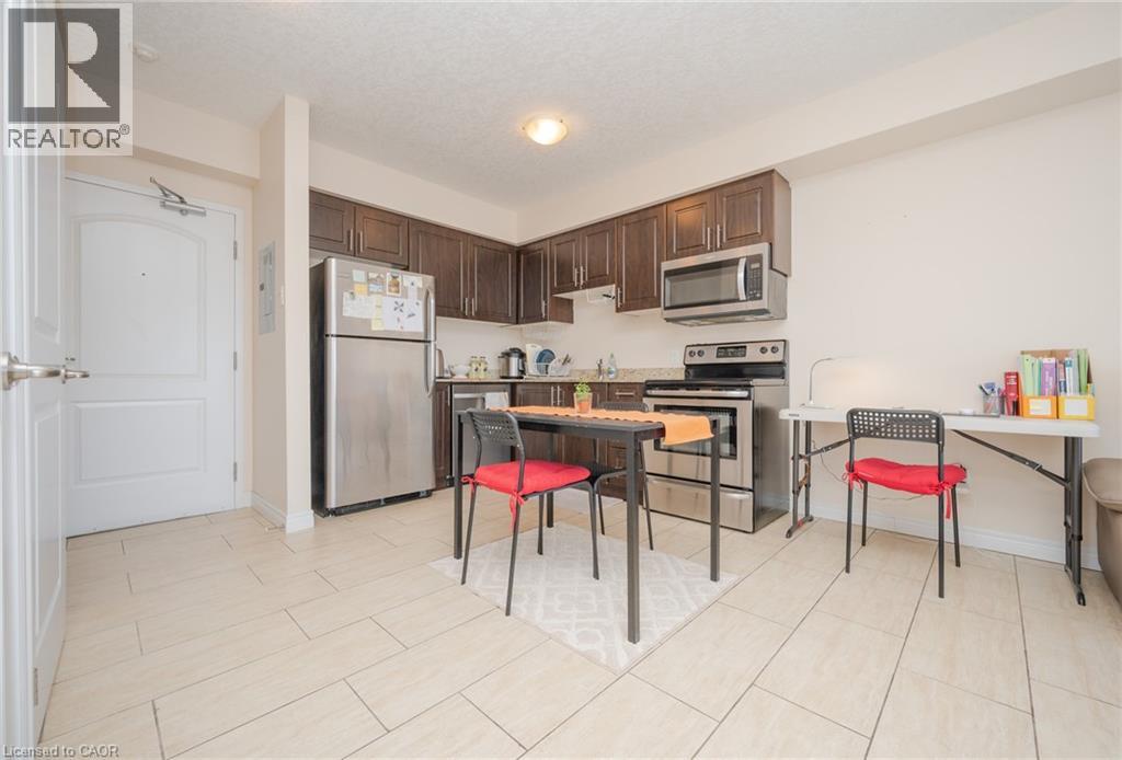 A kitchen with a table and chairs in the middle of the room.