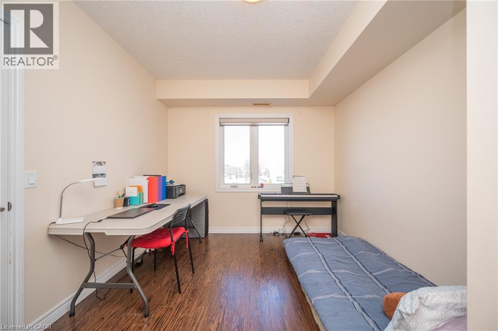 A bedroom with a bed, desk, and chair.
