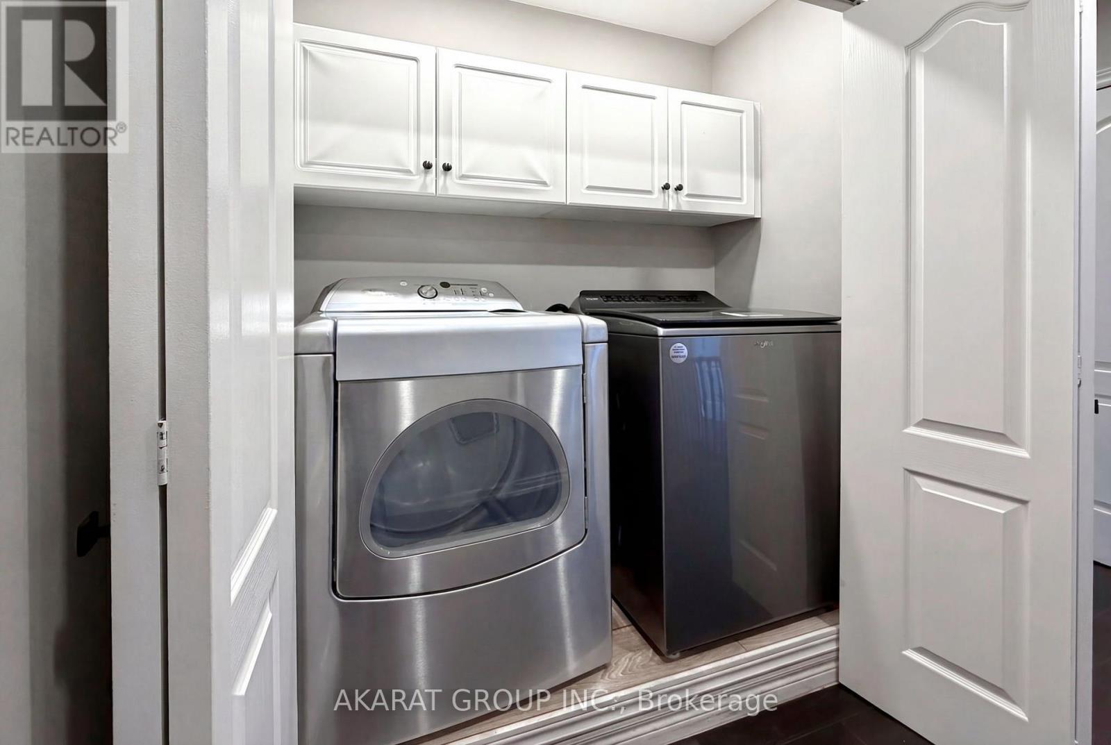 A kitchen with a dishwasher and a washing machine.