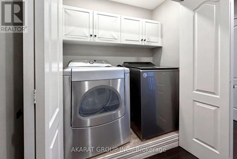 A kitchen with a dishwasher and a washing machine.