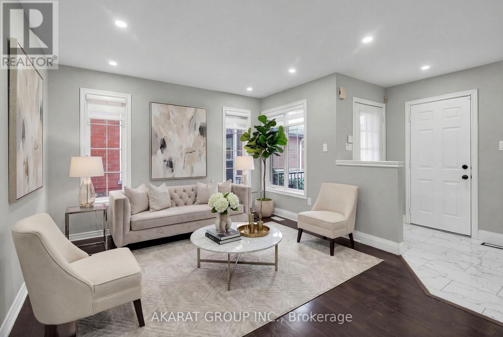 A living room with a couch, chairs, and a coffee table.