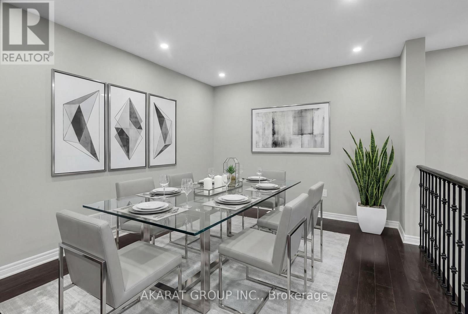 A modern dining room with a glass table and chairs.