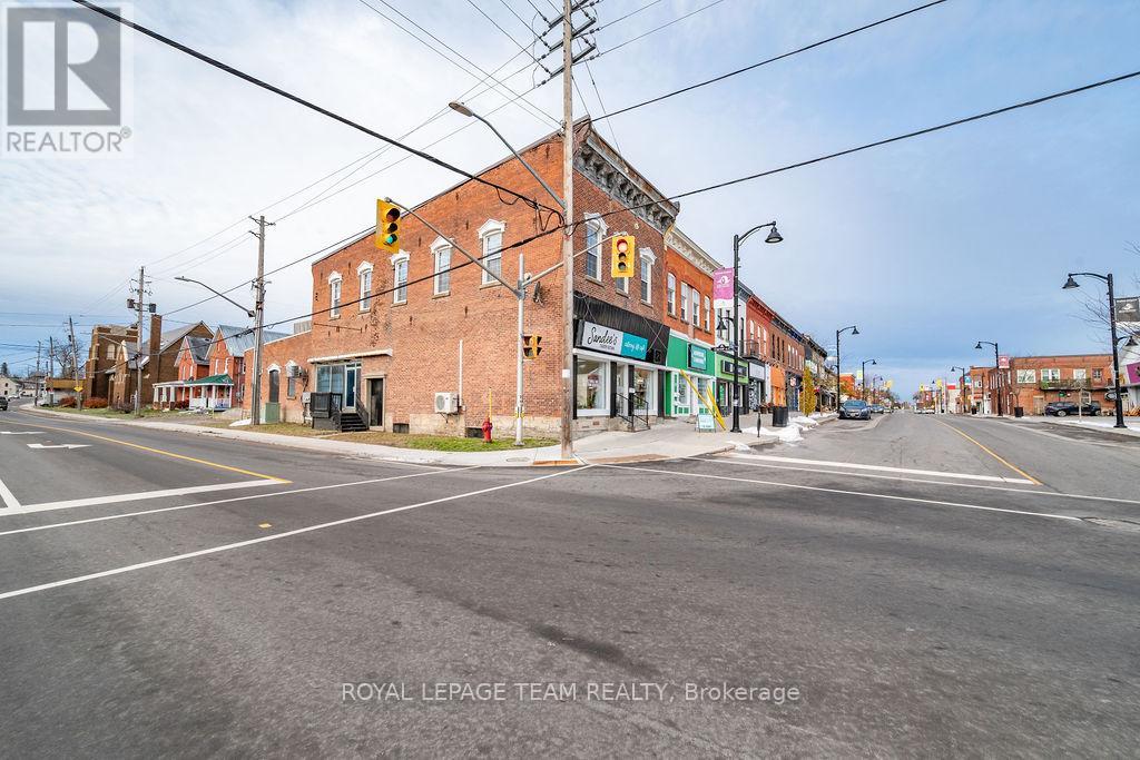 A street view of a town with a building that has a sign that says "REALTOR" on it.