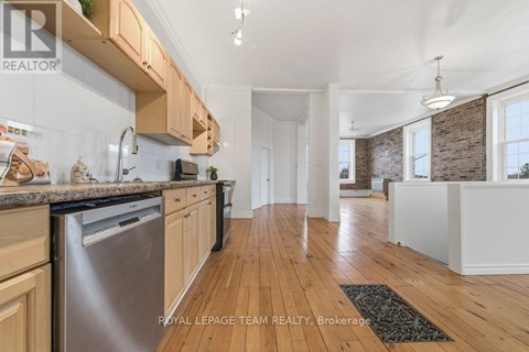 A kitchen with wooden cabinets and a dishwasher.