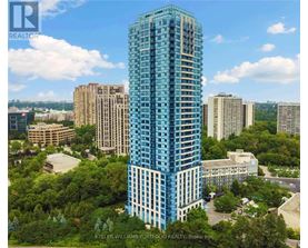 A tall blue building stands out in a cityscape.