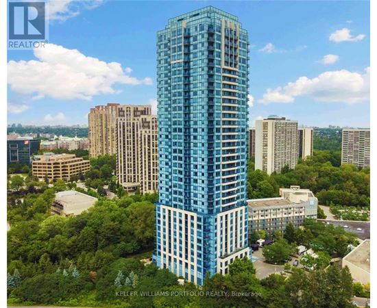 A tall blue building stands out in a cityscape.